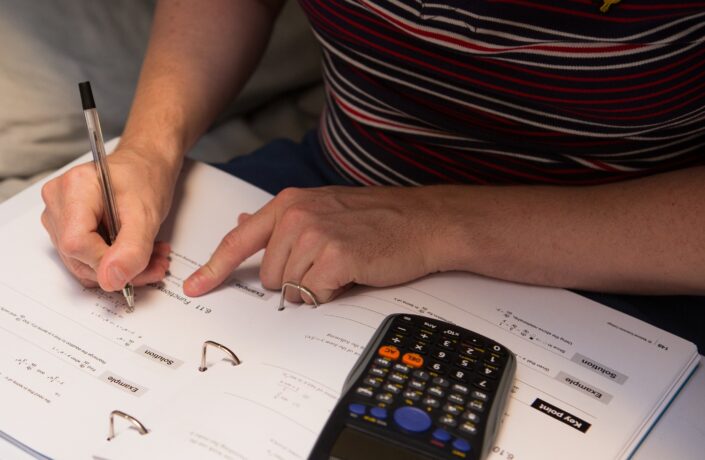 A learner studying a Maths distance learning course in his room.