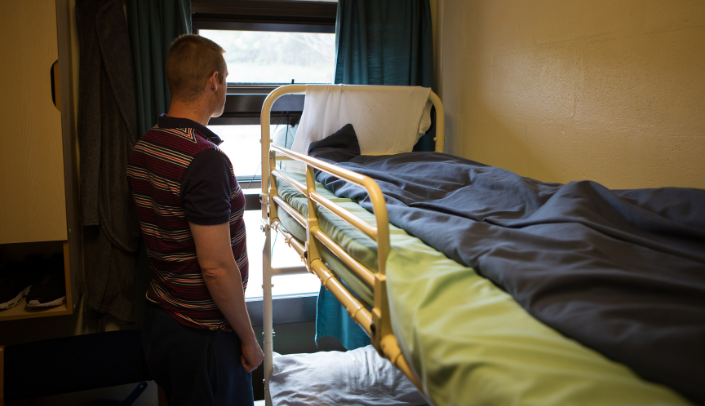 Image of a person in a prison cell