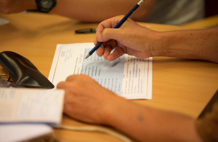 Learner completing a worksheet with a pencil